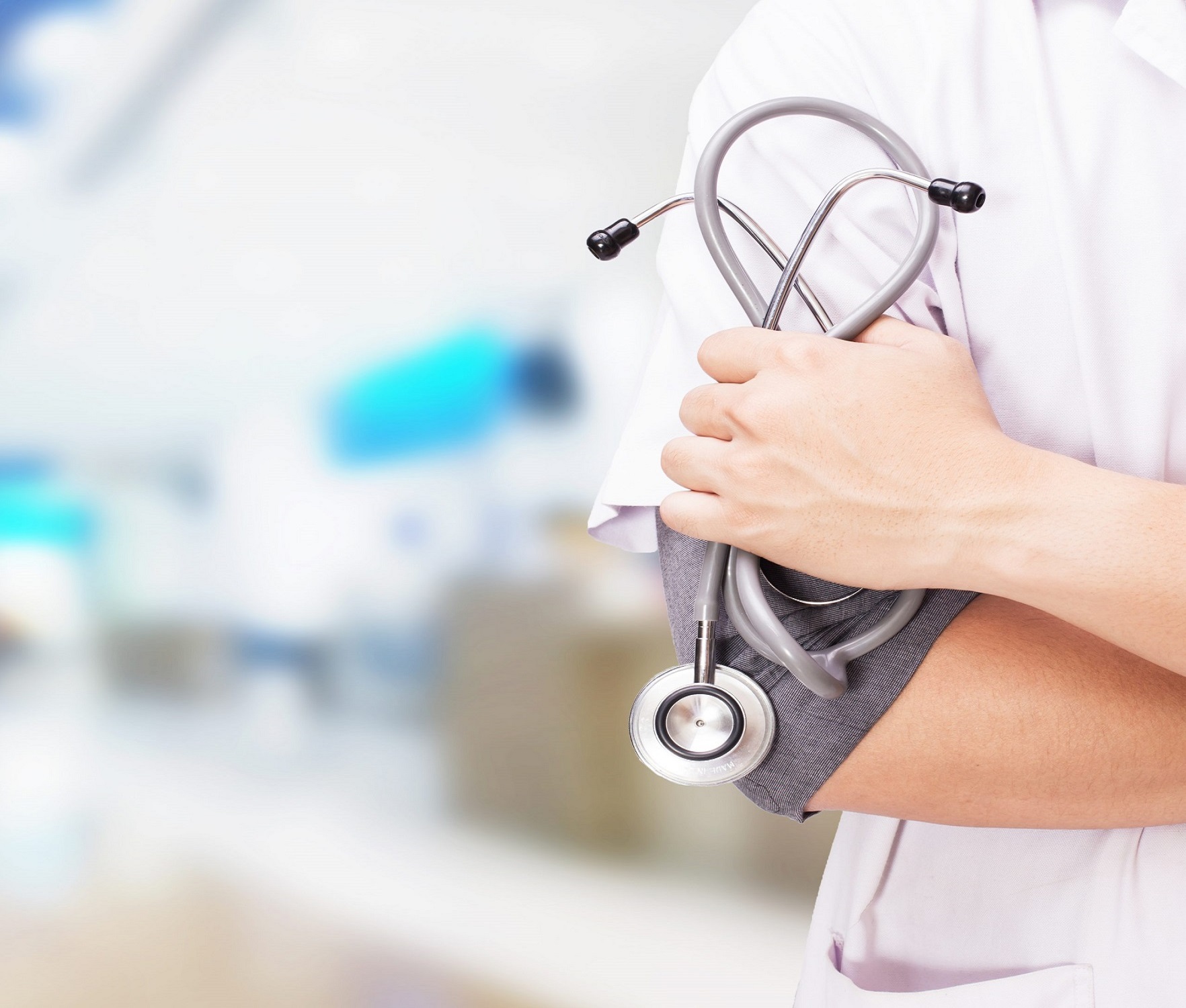 doctor-with-stethoscope-hands-hospital-background-scaled